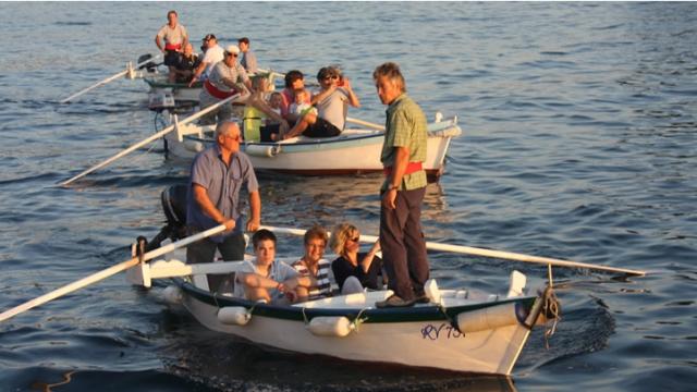 Lighted Batana boat parade and a dinner at the Spacio